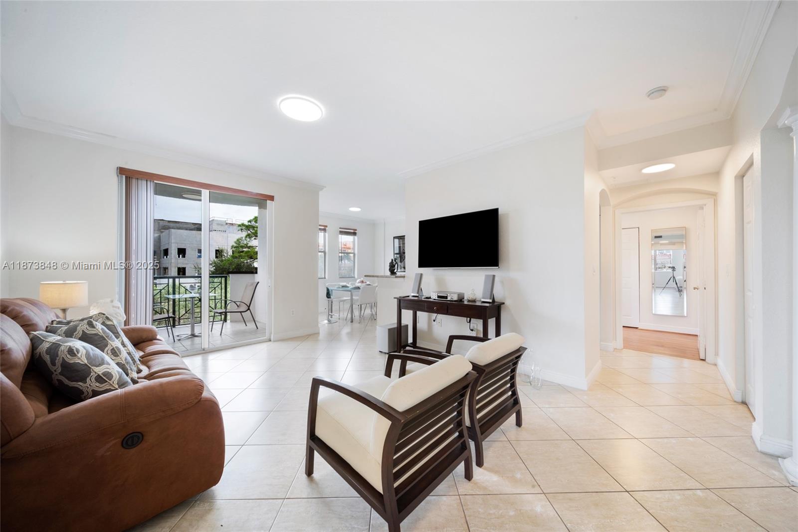 9021 Southwest 94th Street, Unit 310 Miami, FL 33176 - Photo 6 of 41 a living room with furniture and a flat screen tv