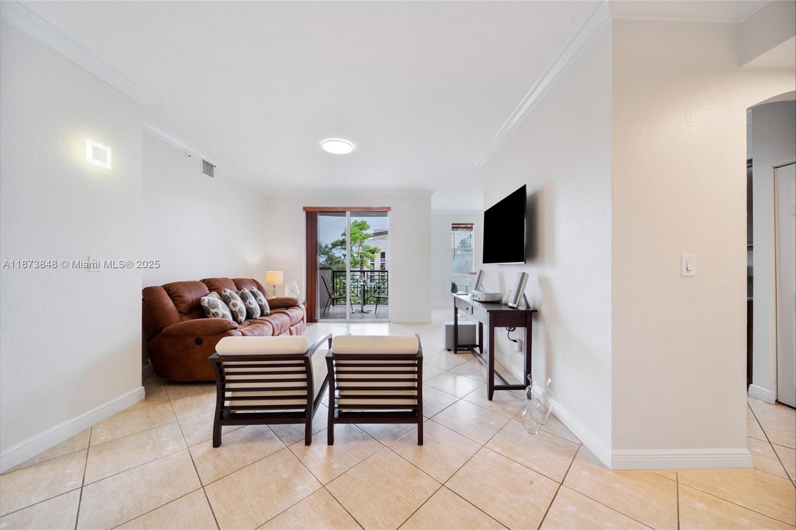 9021 Southwest 94th Street, Unit 310 Miami, FL 33176 - Photo 7 of 41 a living room with furniture and a flat screen tv