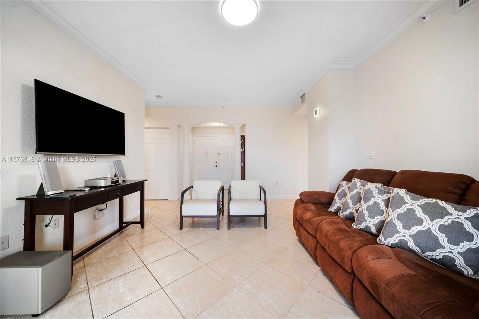 9021 Southwest 94th Street, Unit 310 Miami, FL 33176 - Photo 8 of 41 a living room with furniture and a flat screen tv