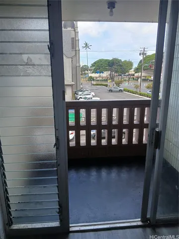 a view of a balcony with a floor to ceiling window and stairs