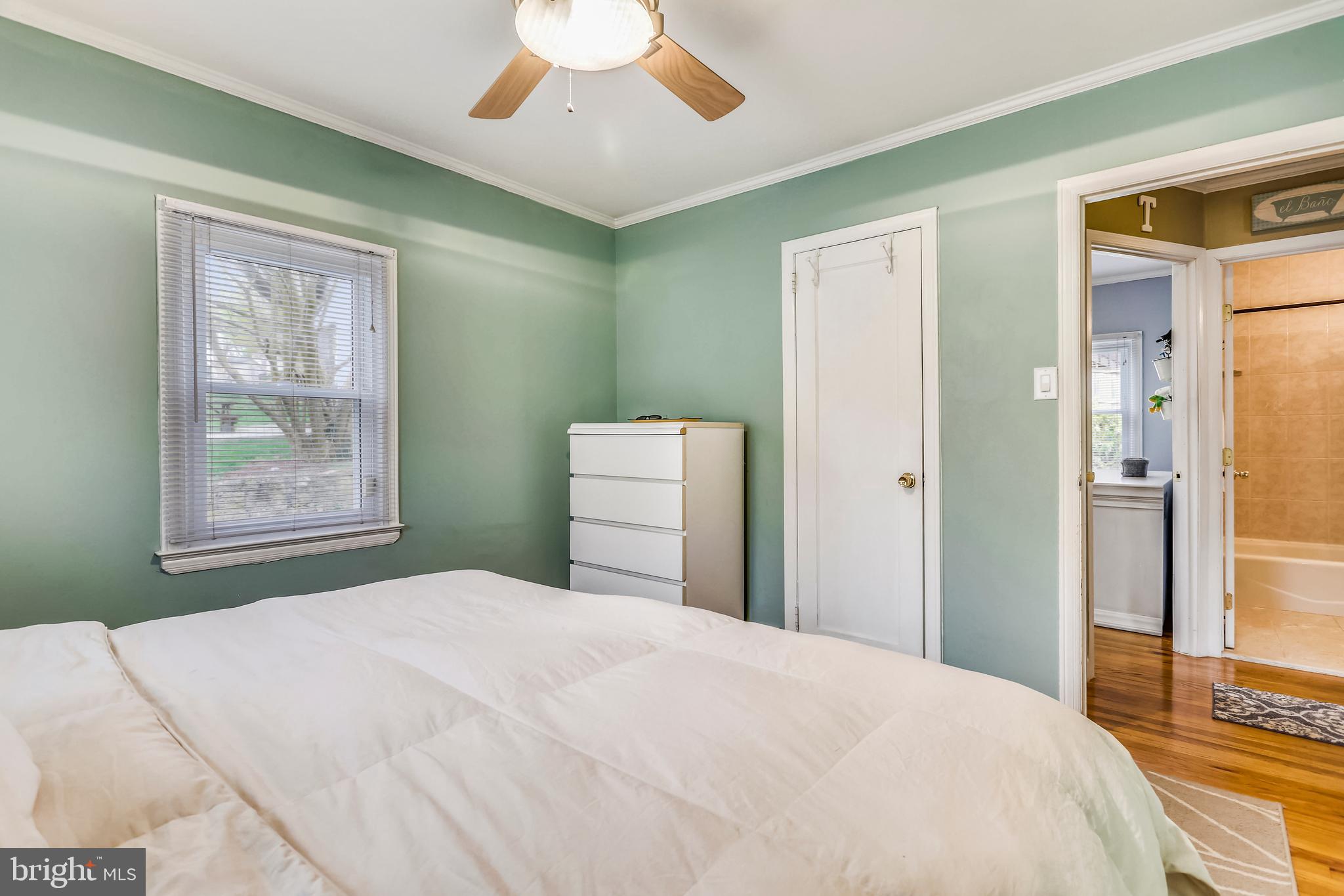 4319 Fernhill Road Silver Spring, MD 20906 - Photo 11 of 29 a bedroom with a bed and a chandelier