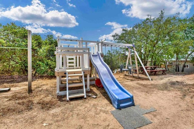a view of park with swings and trees