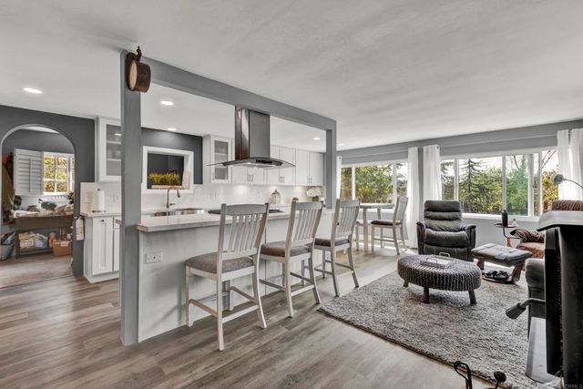 a kitchen with kitchen island granite countertop lots of counter top space and stainless steel appliances