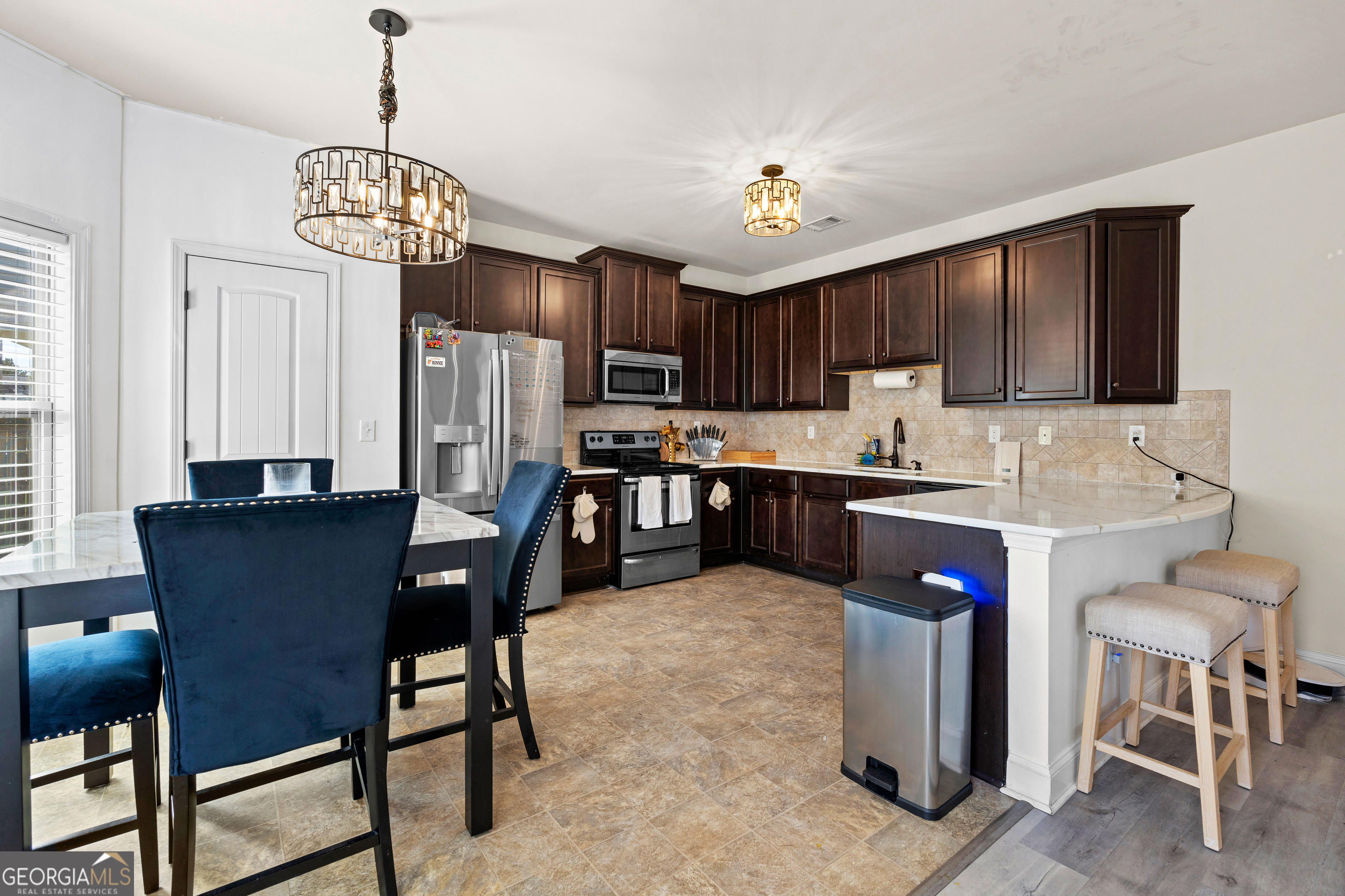 112 Truman Court Jackson, GA 30233 - Photo 12 of 42 a view of kitchen with granite countertop cabinets table and chairs
