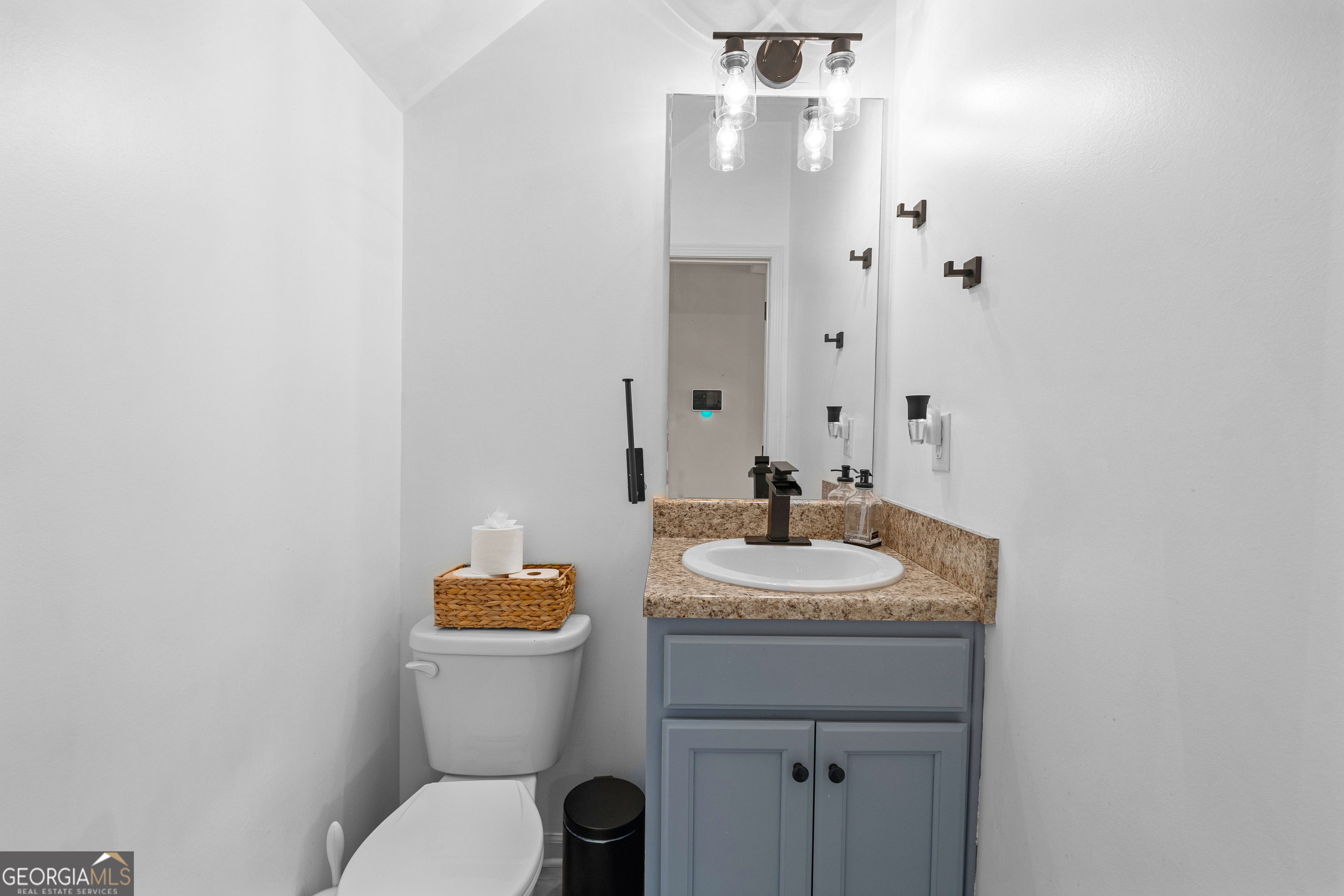 112 Truman Court Jackson, GA 30233 - Photo 17 of 42 a bathroom with a granite countertop sink toilet and mirror