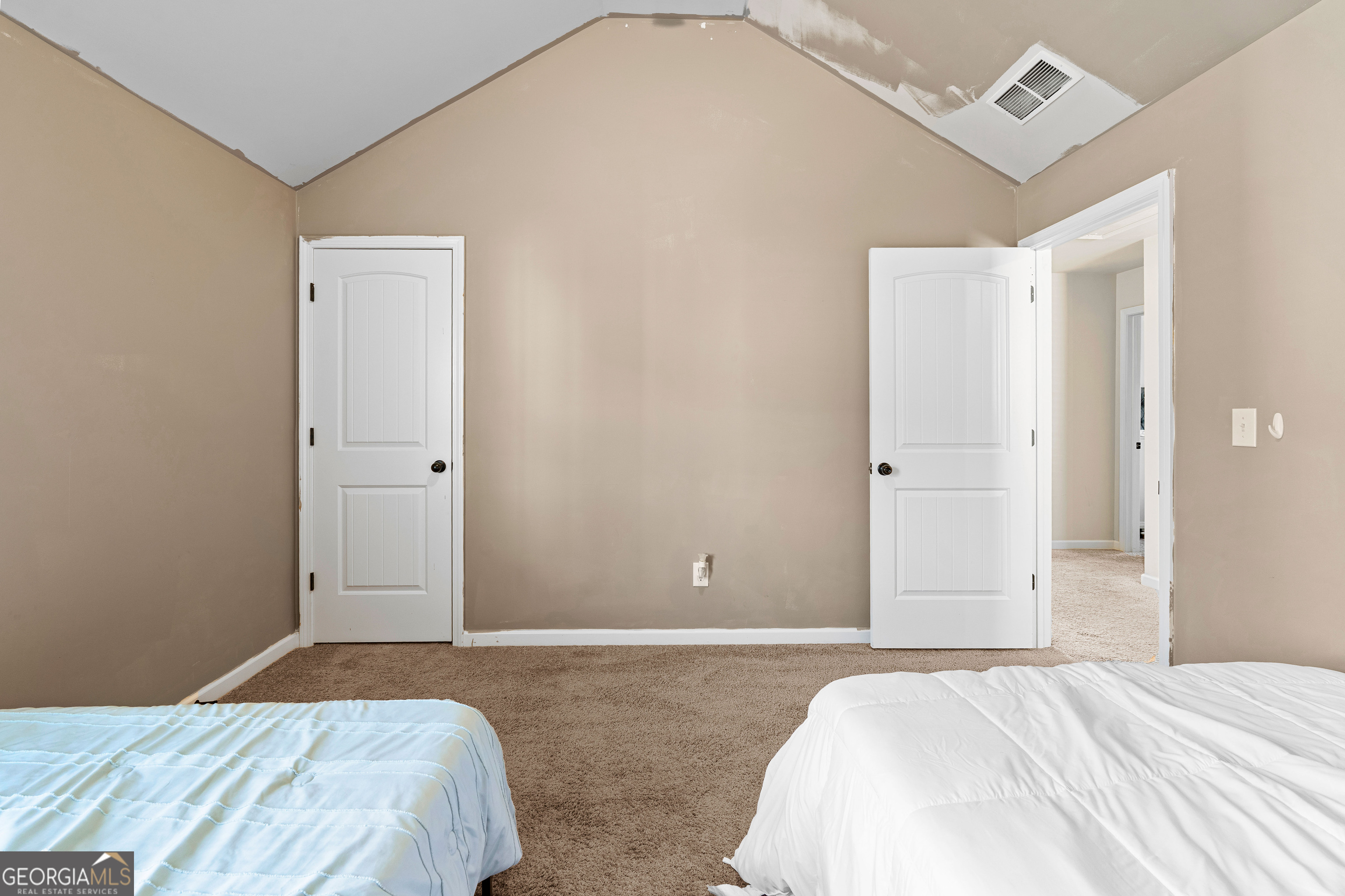 112 Truman Court Jackson, GA 30233 - Photo 23 of 42 a bedroom with a bed and a mirror