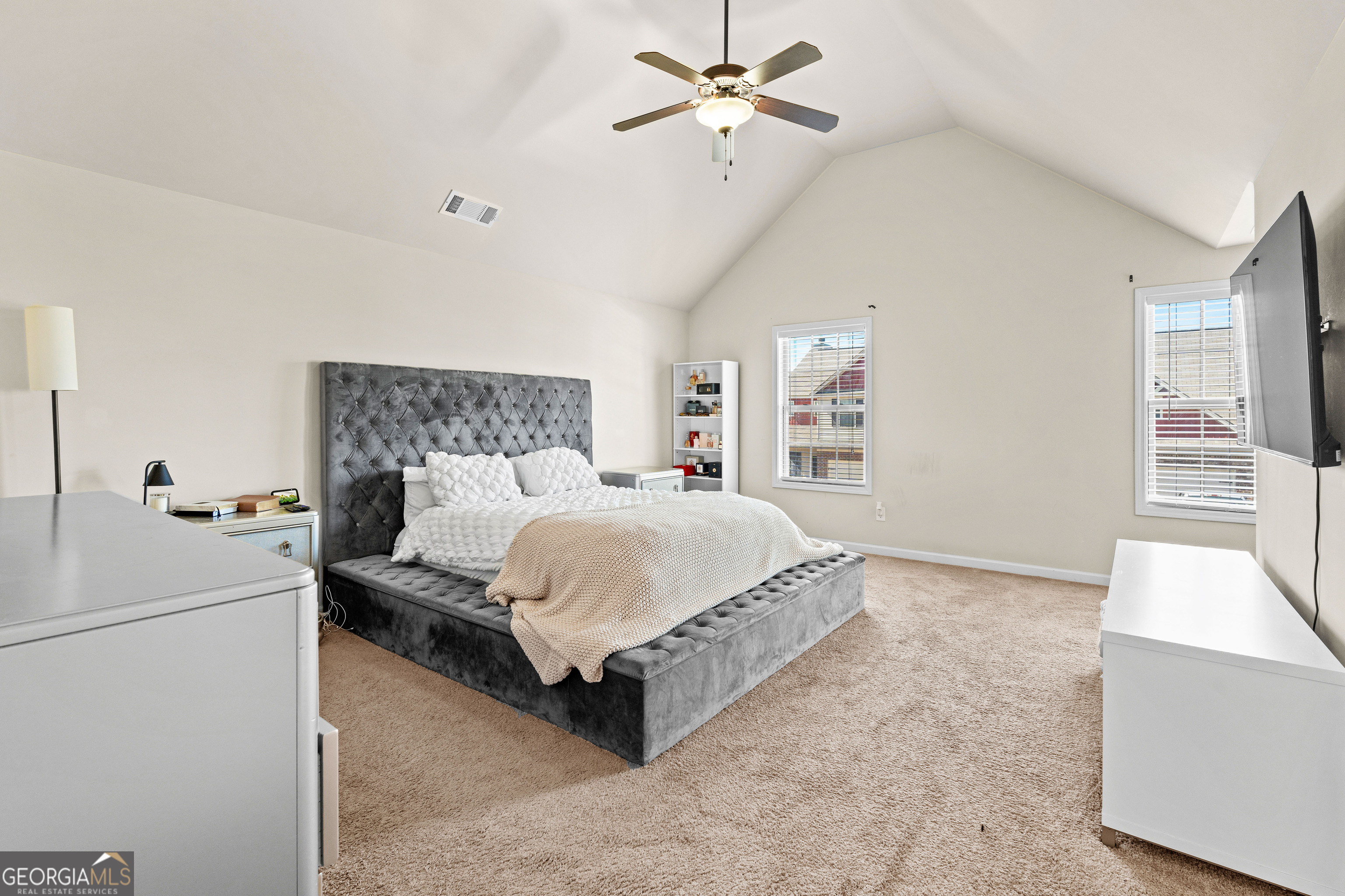 112 Truman Court Jackson, GA 30233 - Photo 29 of 42 a bed room with a bed and a chandelier