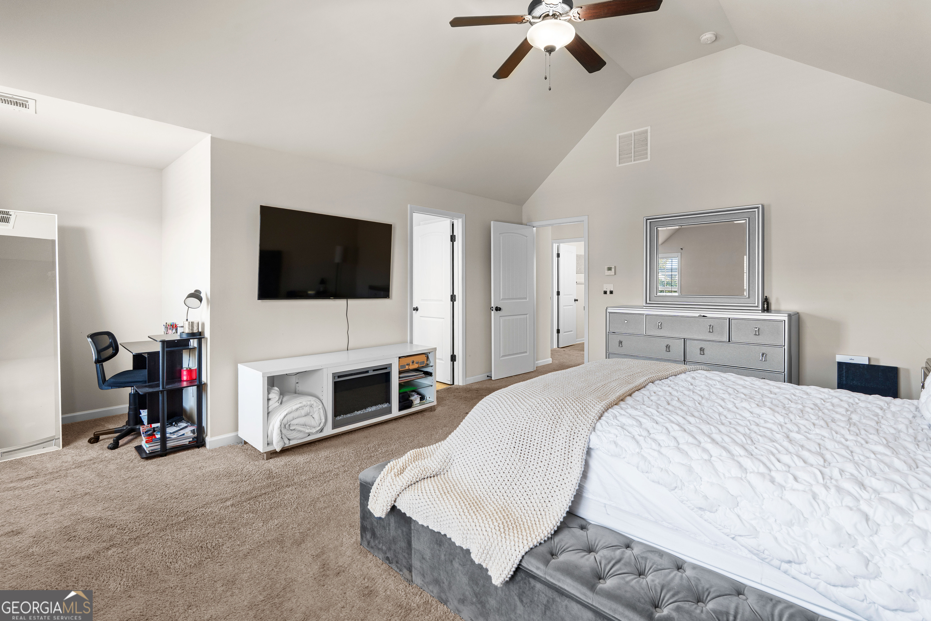 112 Truman Court Jackson, GA 30233 - Photo 31 of 42 a spacious bedroom with a bed and a flat screen tv