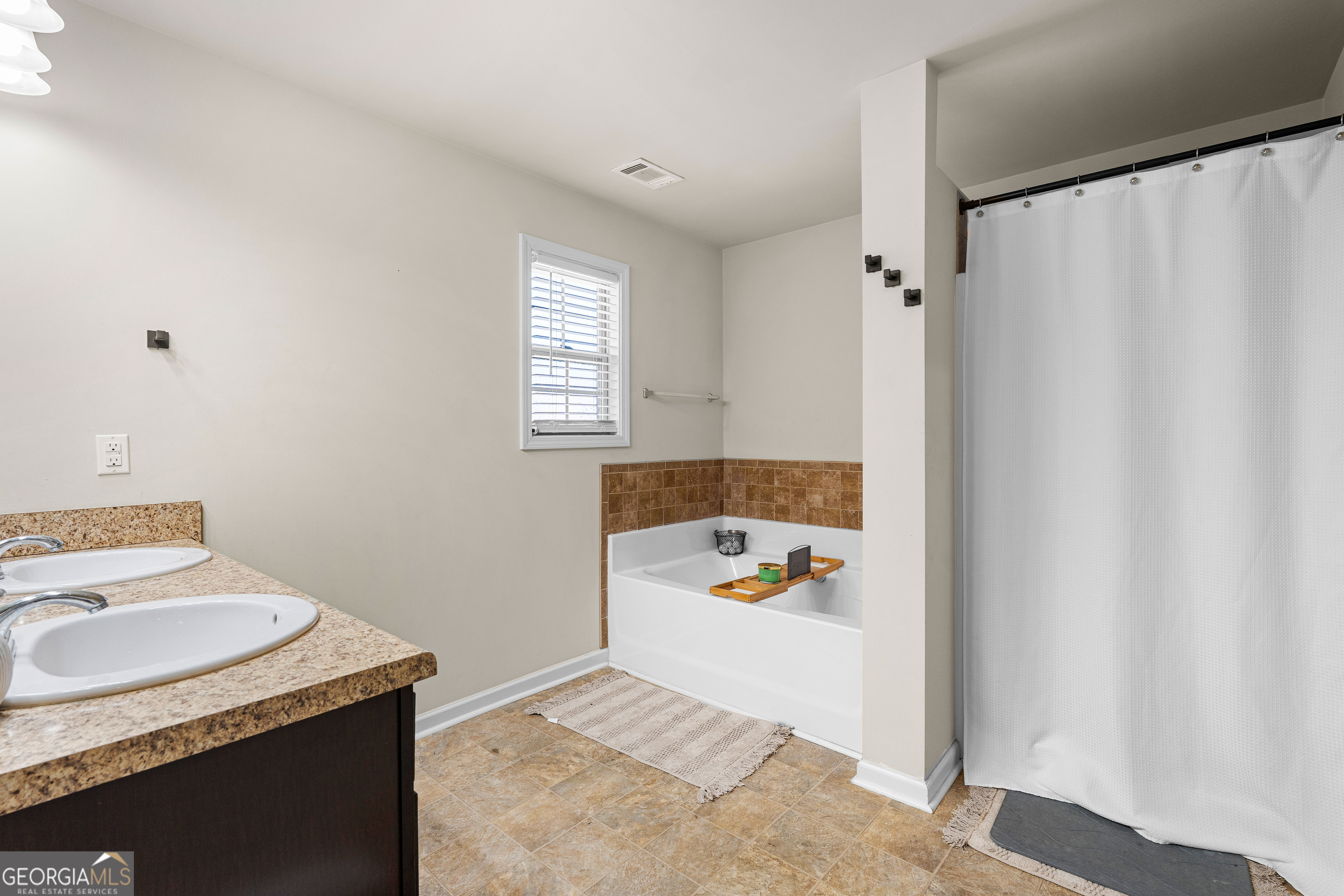 112 Truman Court Jackson, GA 30233 - Photo 33 of 42 a bathroom with a sink toilet and window