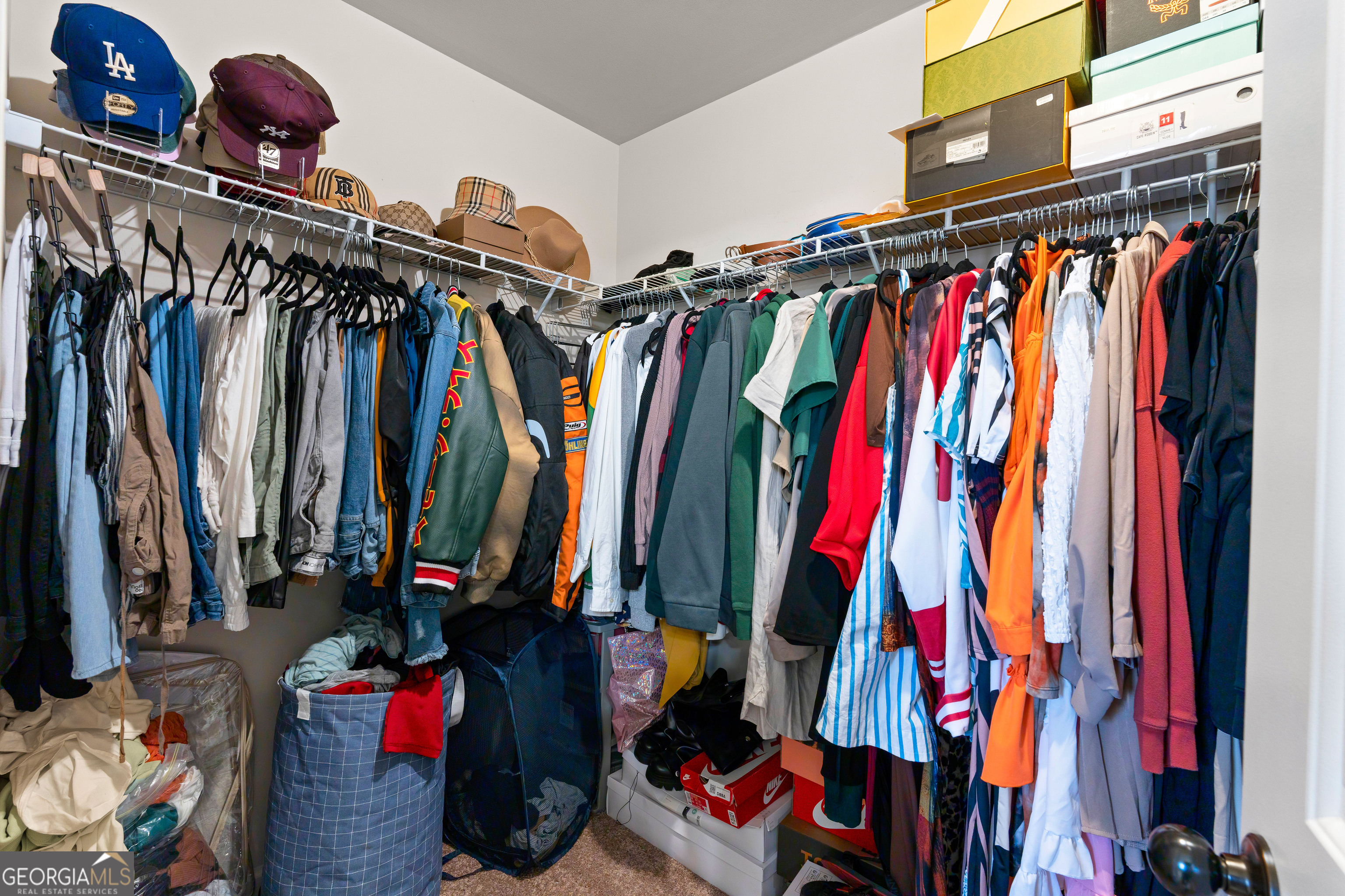 112 Truman Court Jackson, GA 30233 - Photo 35 of 42 a view of walk in closet with clothes and shoes