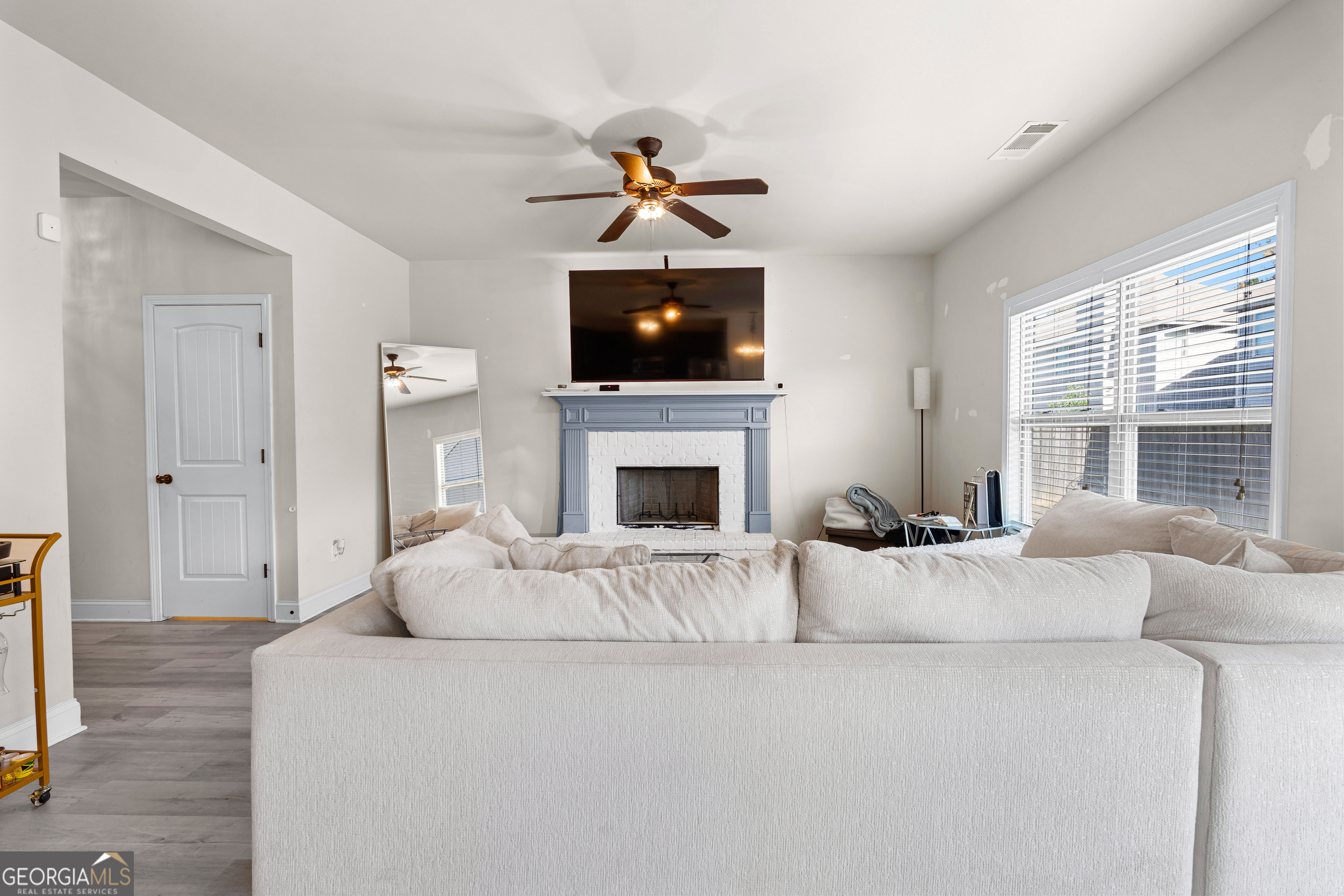 112 Truman Court Jackson, GA 30233 - Photo 7 of 42 a living room with furniture a flat screen tv and a fireplace