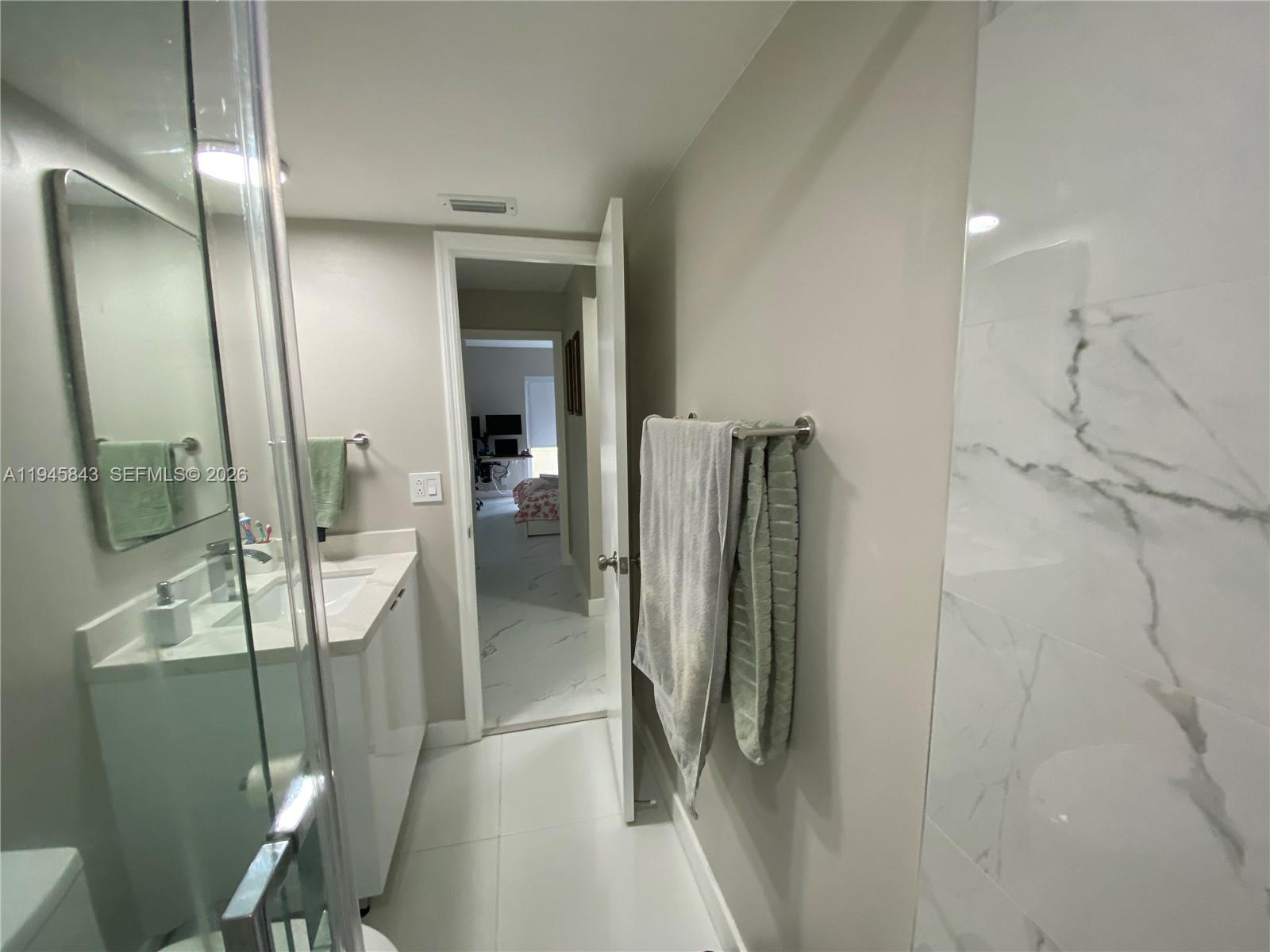 7743 Southwest 86th Street, Unit D129 Miami, FL 33143 - Photo 11 of 17 a bathroom with a shower and a mirror