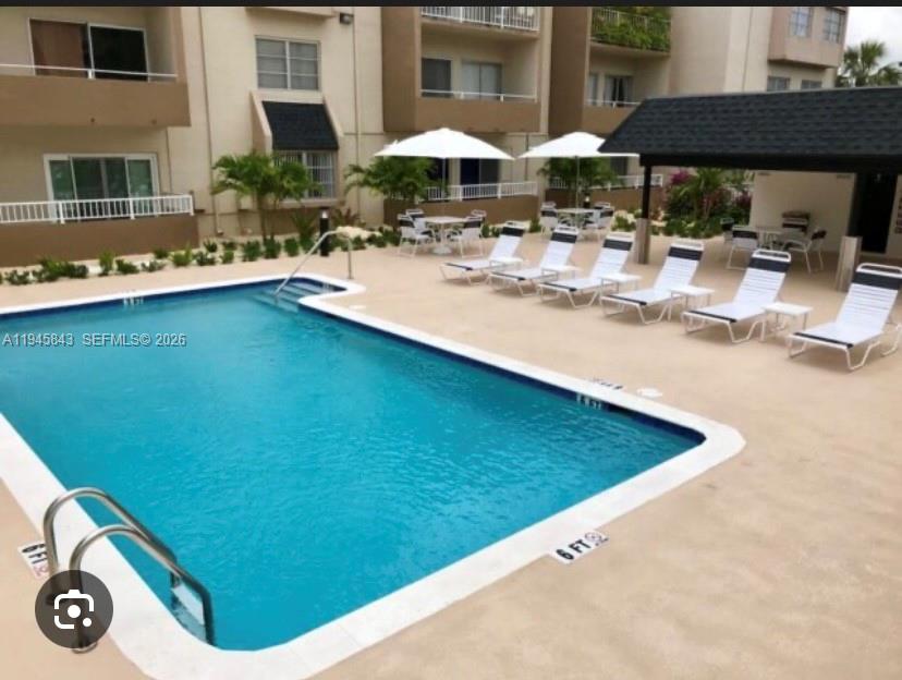 7743 Southwest 86th Street, Unit D129 Miami, FL 33143 - Photo 15 of 17 a view of swimming pool with outdoor seating
