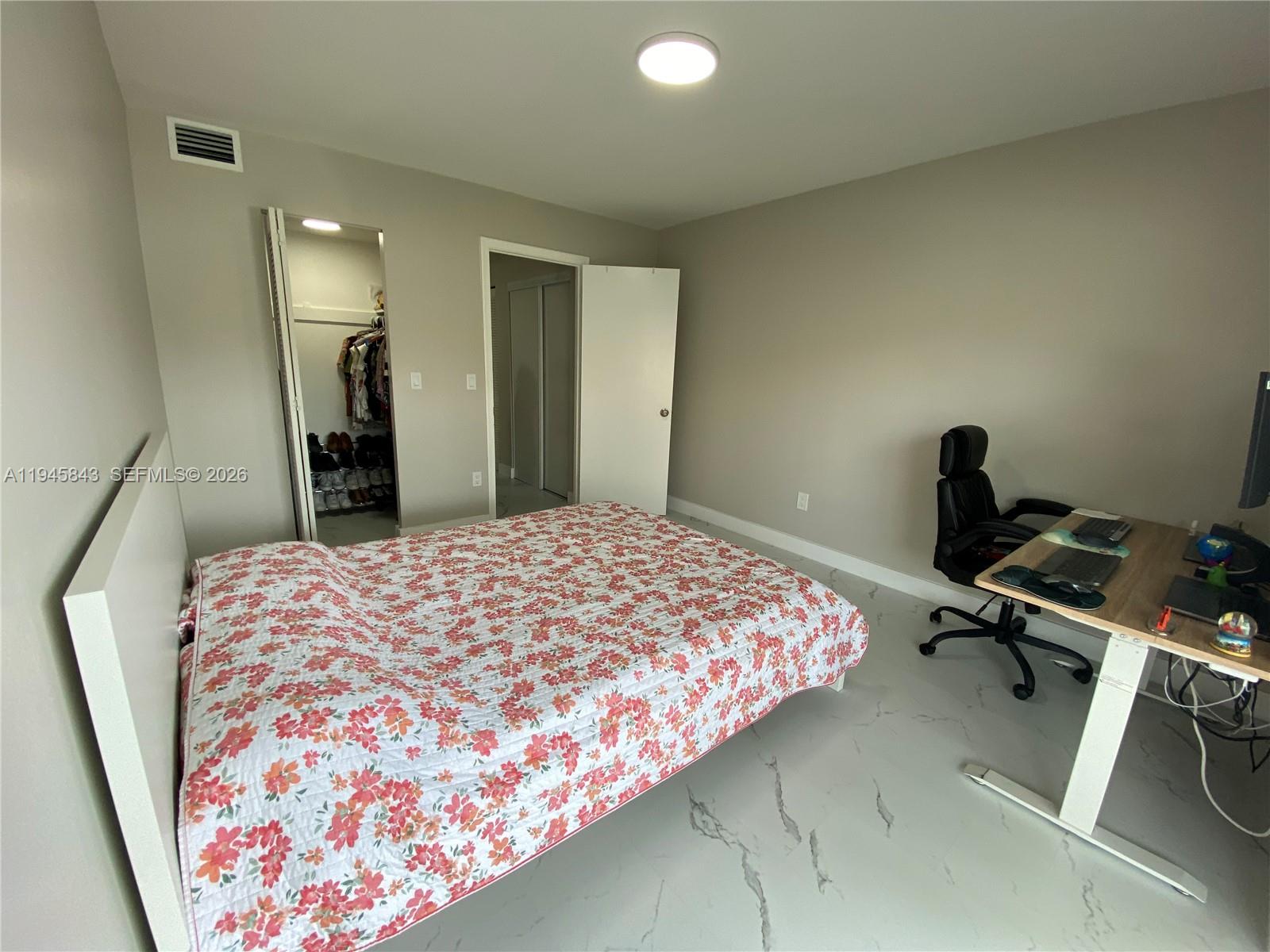 7743 Southwest 86th Street, Unit D129 Miami, FL 33143 - Photo 9 of 17 a bedroom with a bed and a chair