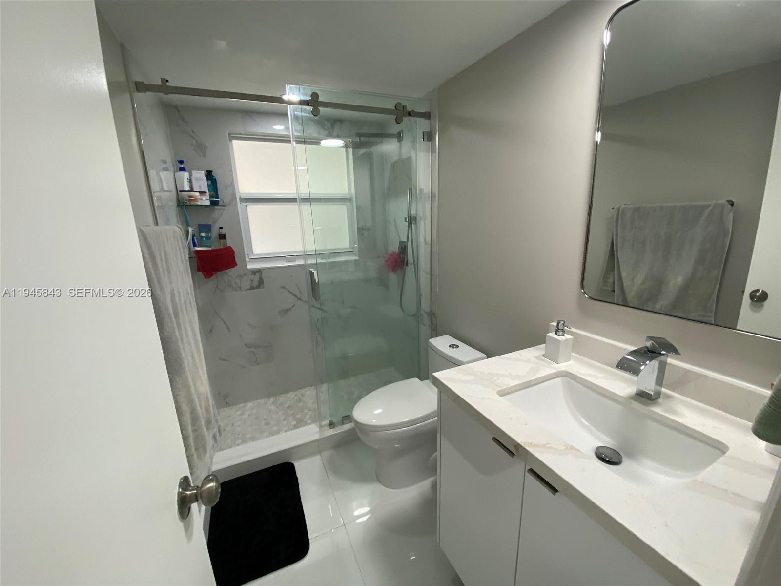 7743 Southwest 86th Street, Unit D129 Miami, FL 33143 - Photo 10 of 17 a bathroom with a sink toilet and shower
