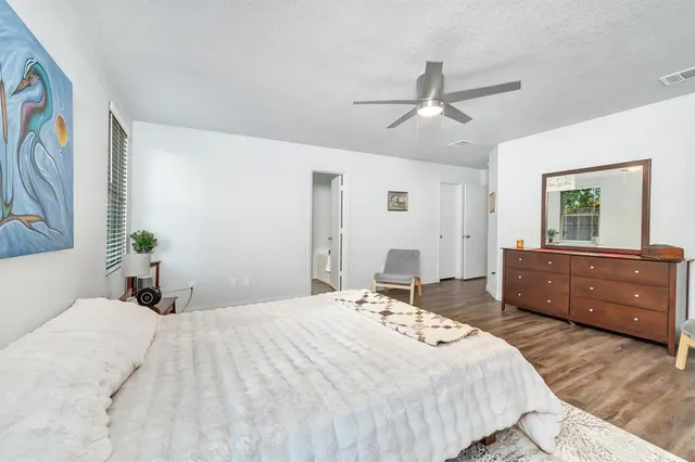 a bedroom with a bed and a dresser