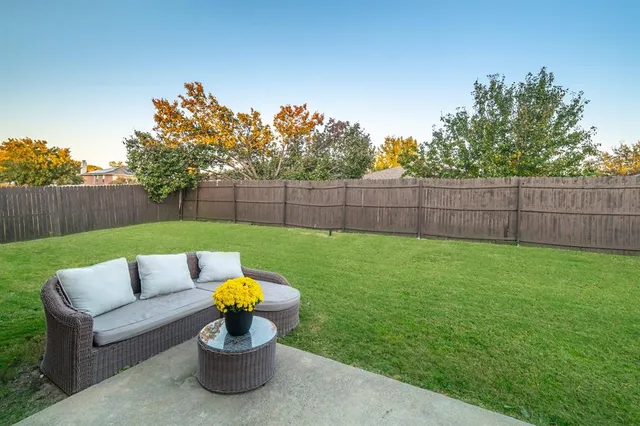 a view of a backyard with sitting area and entertaining space