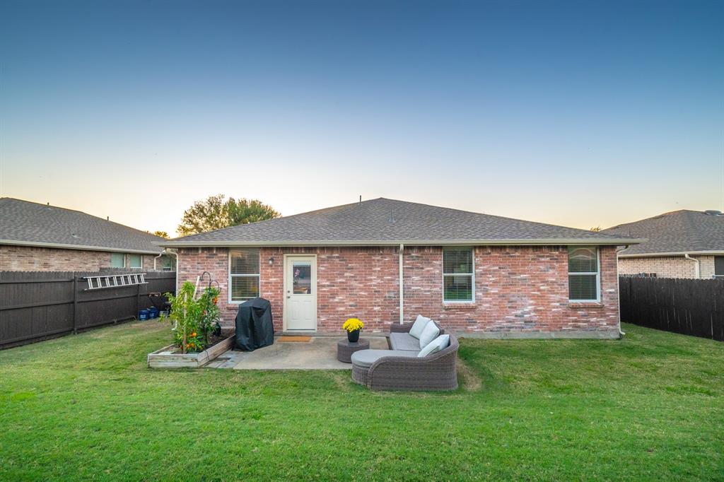 2633 Rockport Lane Little Elm, TX 75068 - Photo 29 of 39 a front view of house with yard and outdoor seating