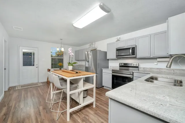 a kitchen with a stove a sink and a refrigerator
