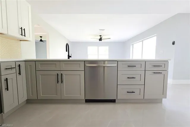 a kitchen with stainless steel appliances a refrigerator stove and microwave