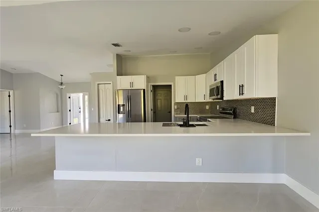 an empty room with windows and outdoor view