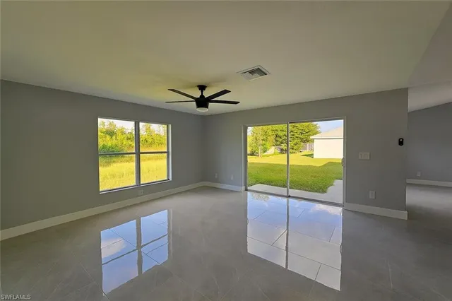 a view of a hallway with a chandelier fan