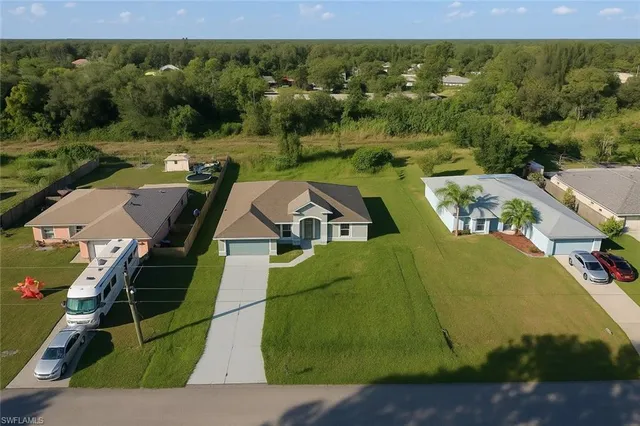 an aerial view of residential houses with outdoor space