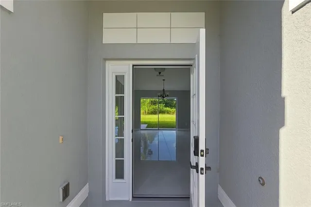 a view of an empty room and a window