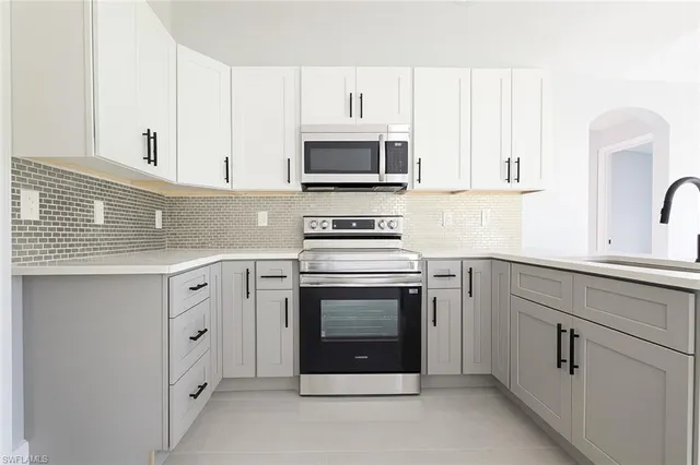 a kitchen with stainless steel appliances a refrigerator sink and cabinets