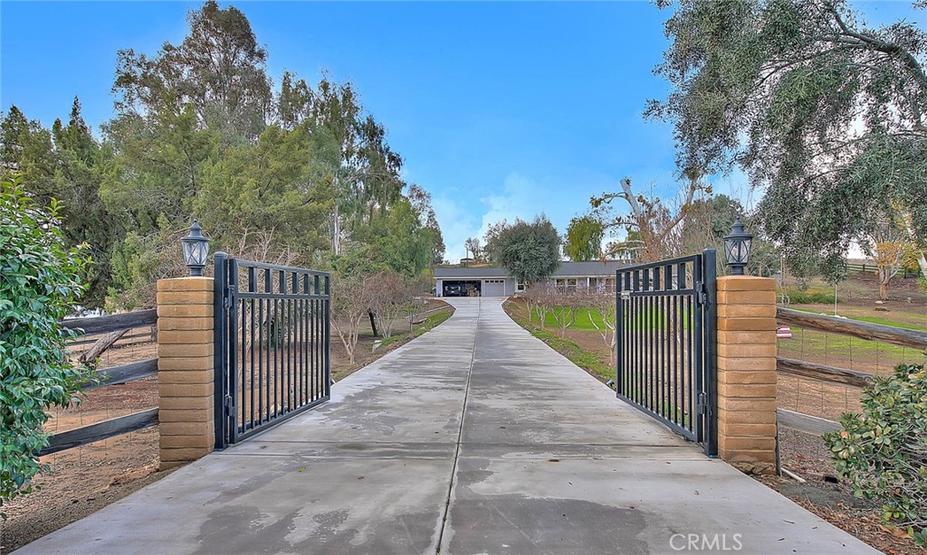 18643 Sussex Road Riverside, CA 92504 - Photo 1 of 1 a view of a pathway with a wrought fence