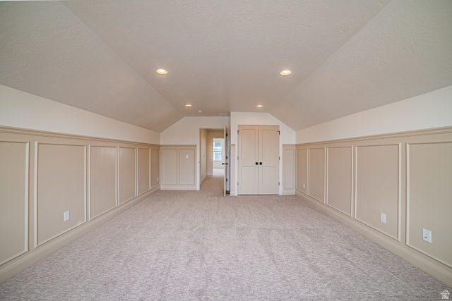 223 South Cottonwood Road, Unit 7501 Vineyard, UT 84059 - Photo 16 of 45 Spacious room featuring vaulted ceilings, recessed lighting, wall paneling, light-toned carpeting, and double-door closet