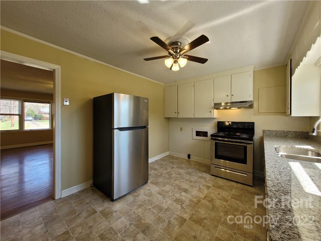 2123 Oakdale Road Charlotte, NC 28216 - Photo 5 of 13 a kitchen with stainless steel appliances a refrigerator and a stove top oven