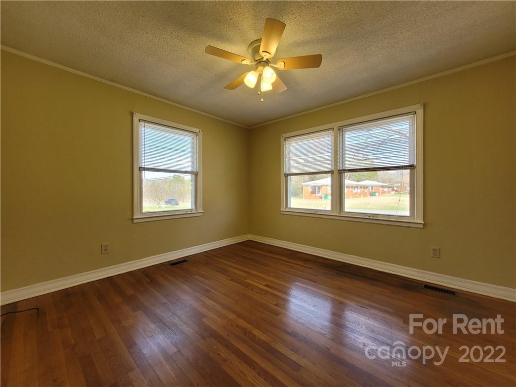 2123 Oakdale Road Charlotte, NC 28216 - Photo 7 of 13 a view of an empty room with window and wooden floor