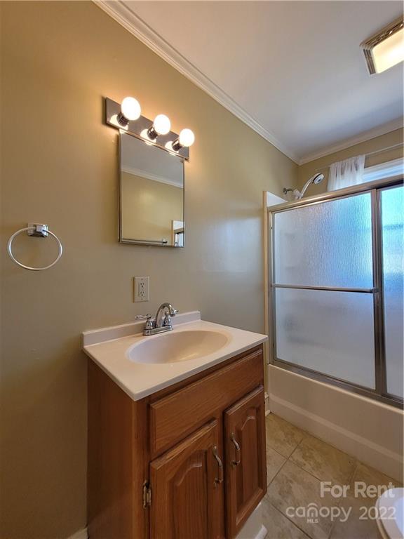 2123 Oakdale Road Charlotte, NC 28216 - Photo 8 of 13 a bathroom with a sink mirror and a shower