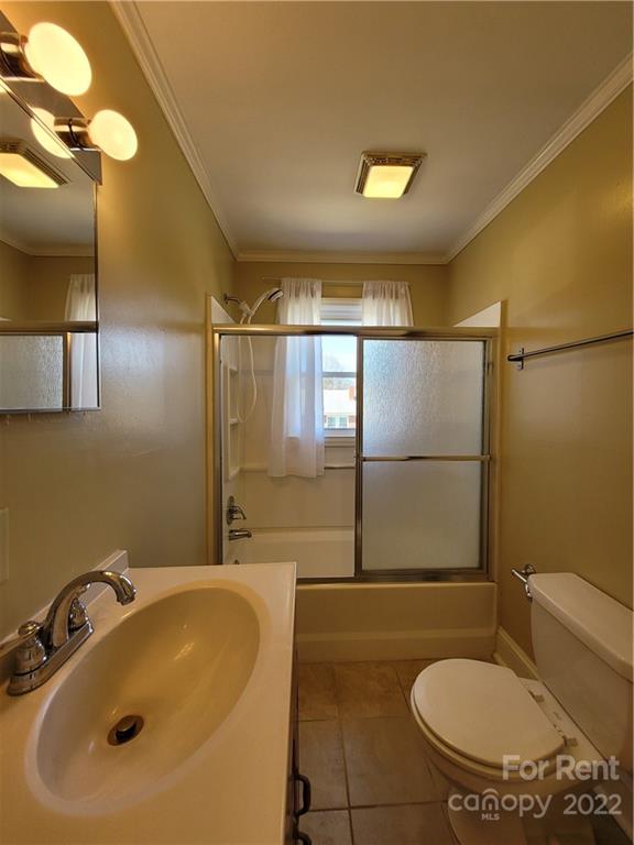 2123 Oakdale Road Charlotte, NC 28216 - Photo 9 of 13 a bathroom with a sink and mirror with toilet
