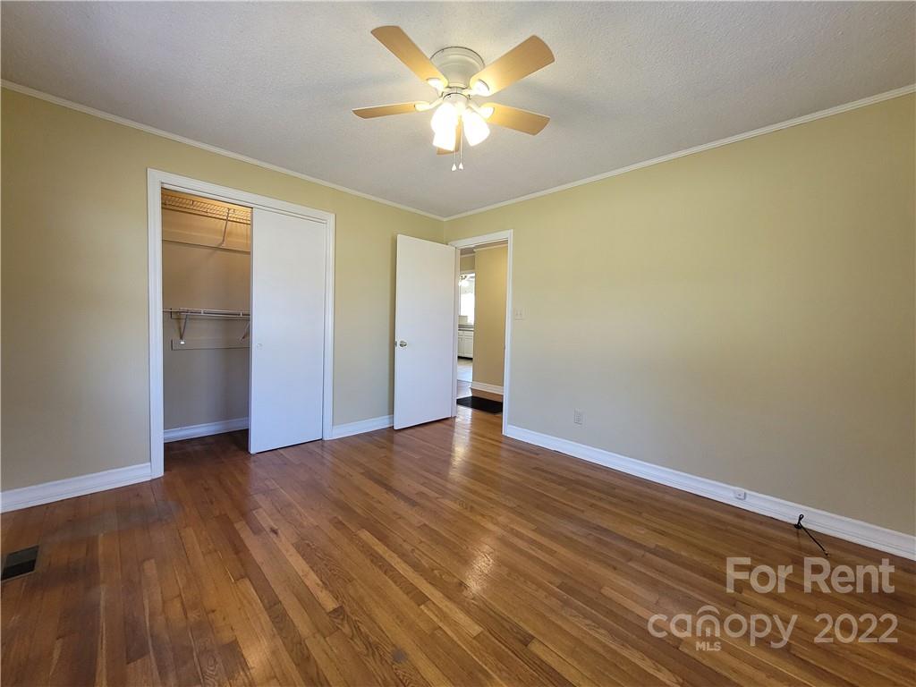 2123 Oakdale Road Charlotte, NC 28216 - Photo 10 of 13 a view of an empty room with window and wooden floor