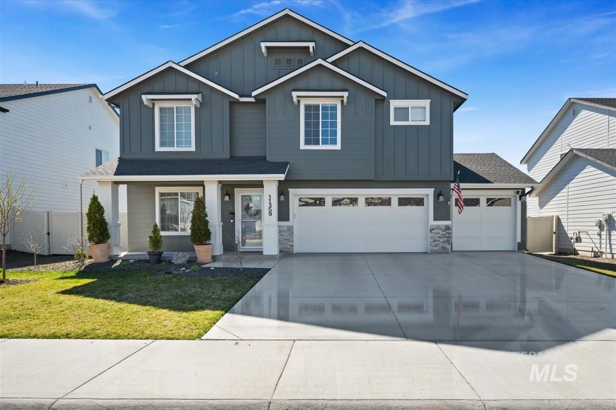 11359 West Langit Street Star, ID 83669 - Photo 1 of 39 Craftsman-style home with board and batten siding, concrete driveway, a porch, a garage, and roof with shingles