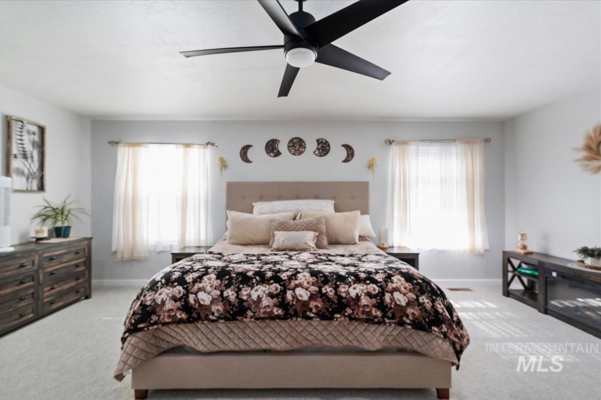 11359 West Langit Street Star, ID 83669 - Photo 11 of 39 Bedroom with light colored carpet and ceiling fan