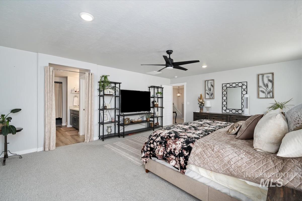 11359 West Langit Street Star, ID 83669 - Photo 13 of 39 Bedroom with light colored carpet, a ceiling fan, connected bathroom, and recessed lighting