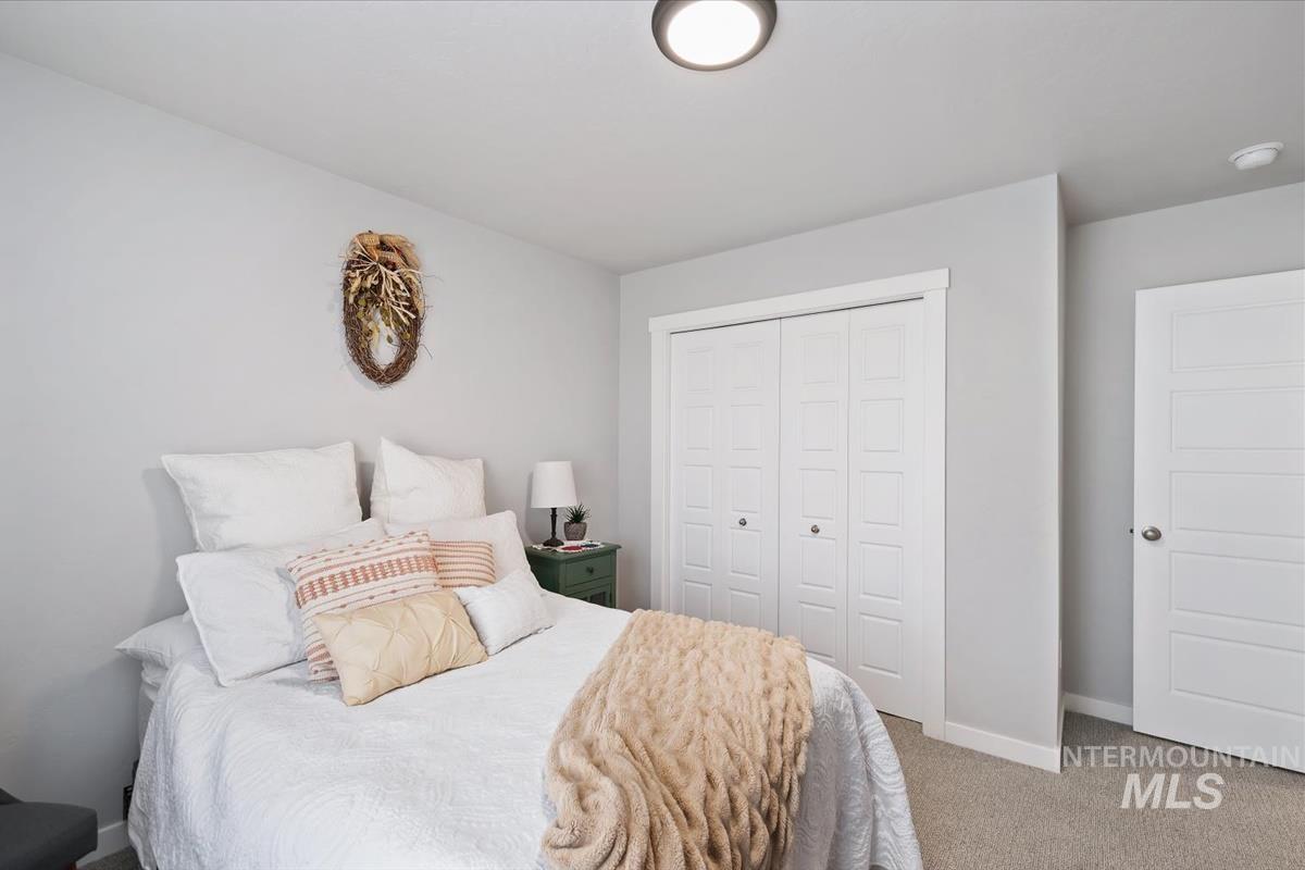 11359 West Langit Street Star, ID 83669 - Photo 18 of 39 Bedroom featuring a closet and light colored carpet