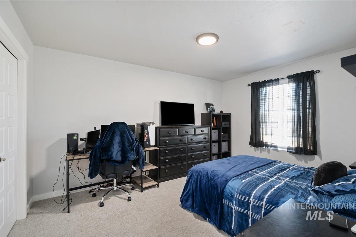 11359 West Langit Street Star, ID 83669 - Photo 19 of 39 Bedroom with light colored carpet and a desk