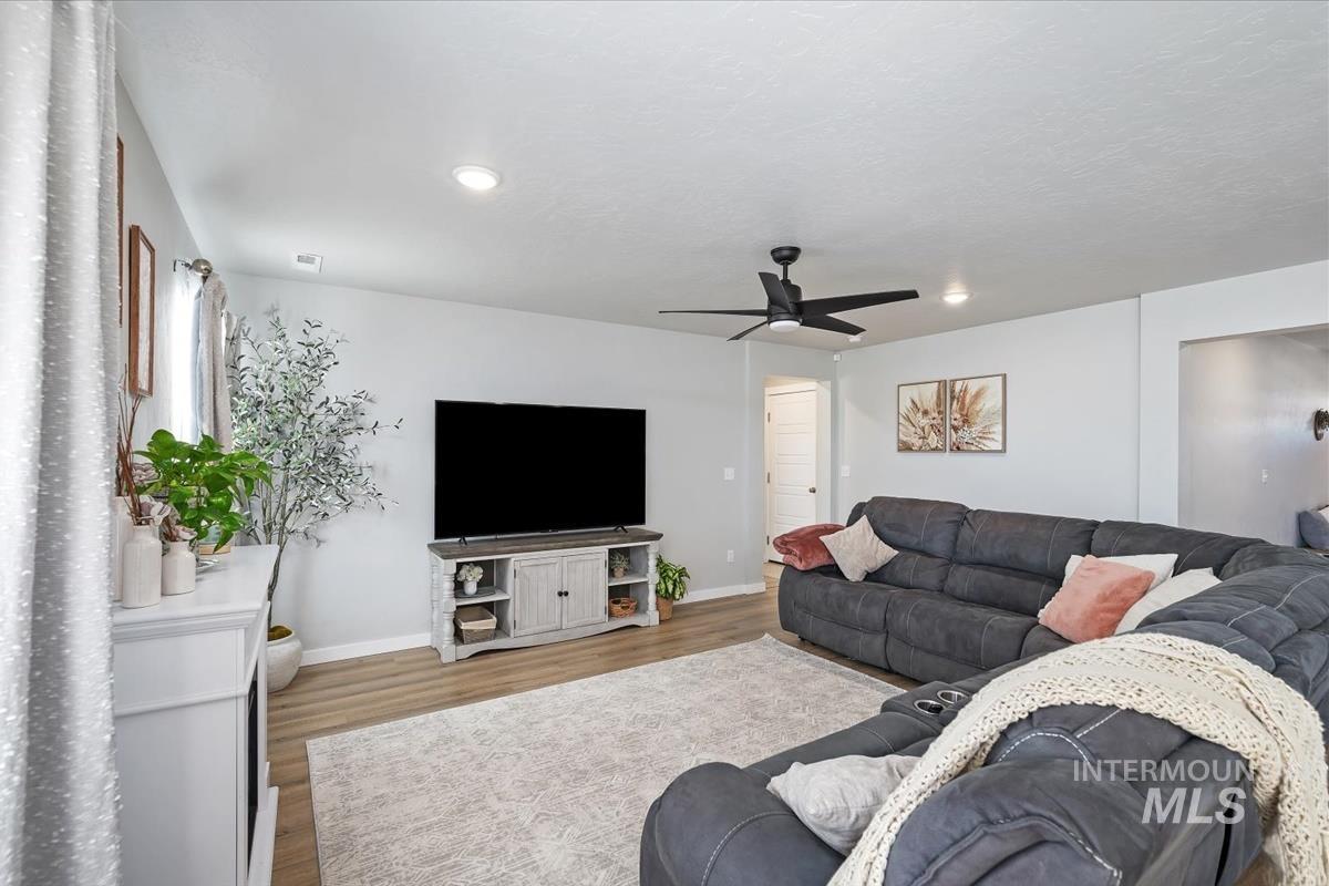 11359 West Langit Street Star, ID 83669 - Photo 22 of 39 Living area with wood finished floors and ceiling fan