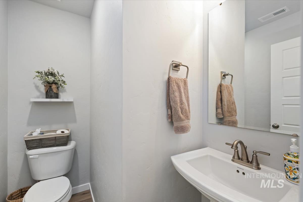 11359 West Langit Street Star, ID 83669 - Photo 27 of 39 Bathroom featuring toilet and wood finished floors