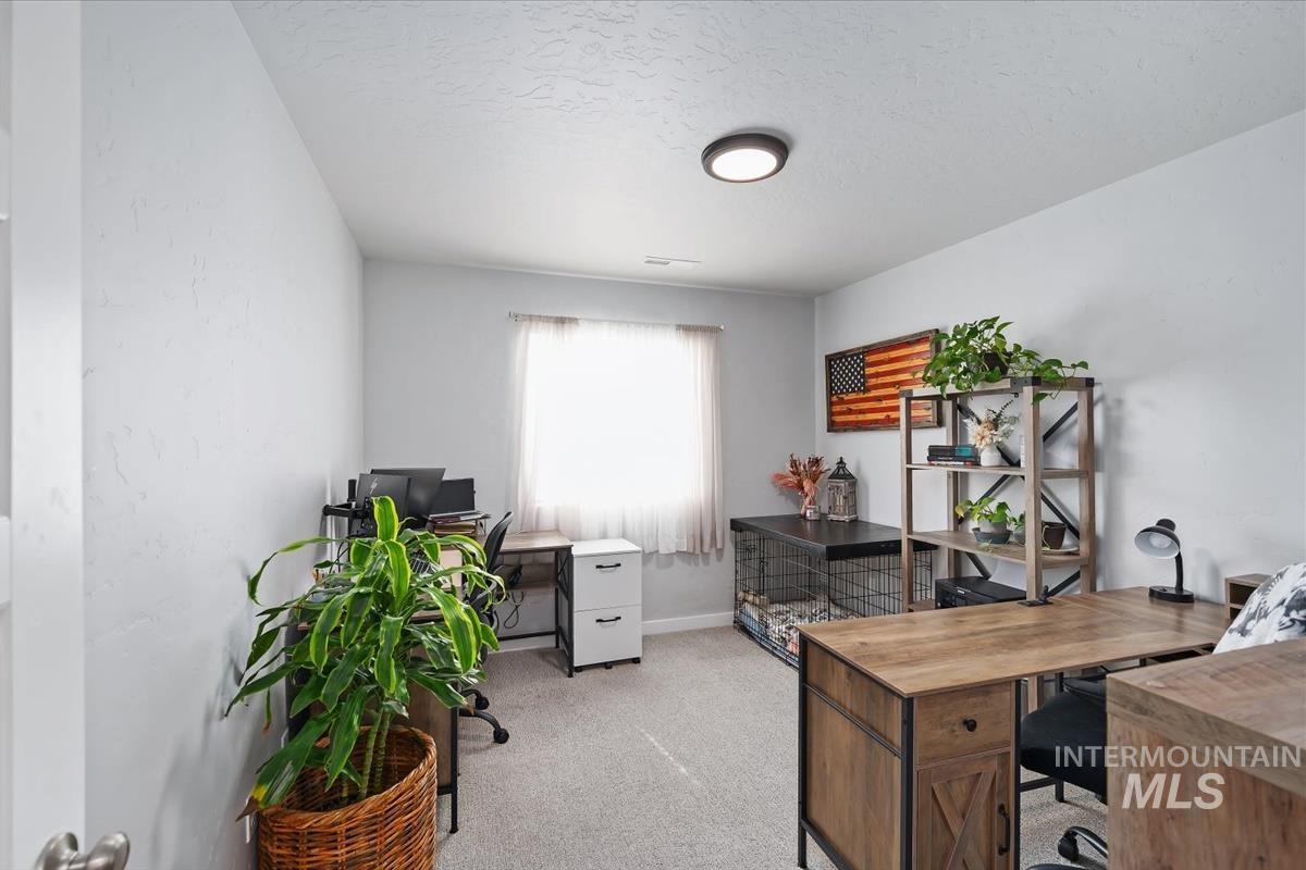 11359 West Langit Street Star, ID 83669 - Photo 28 of 39 Home office featuring light colored carpet and a textured ceiling