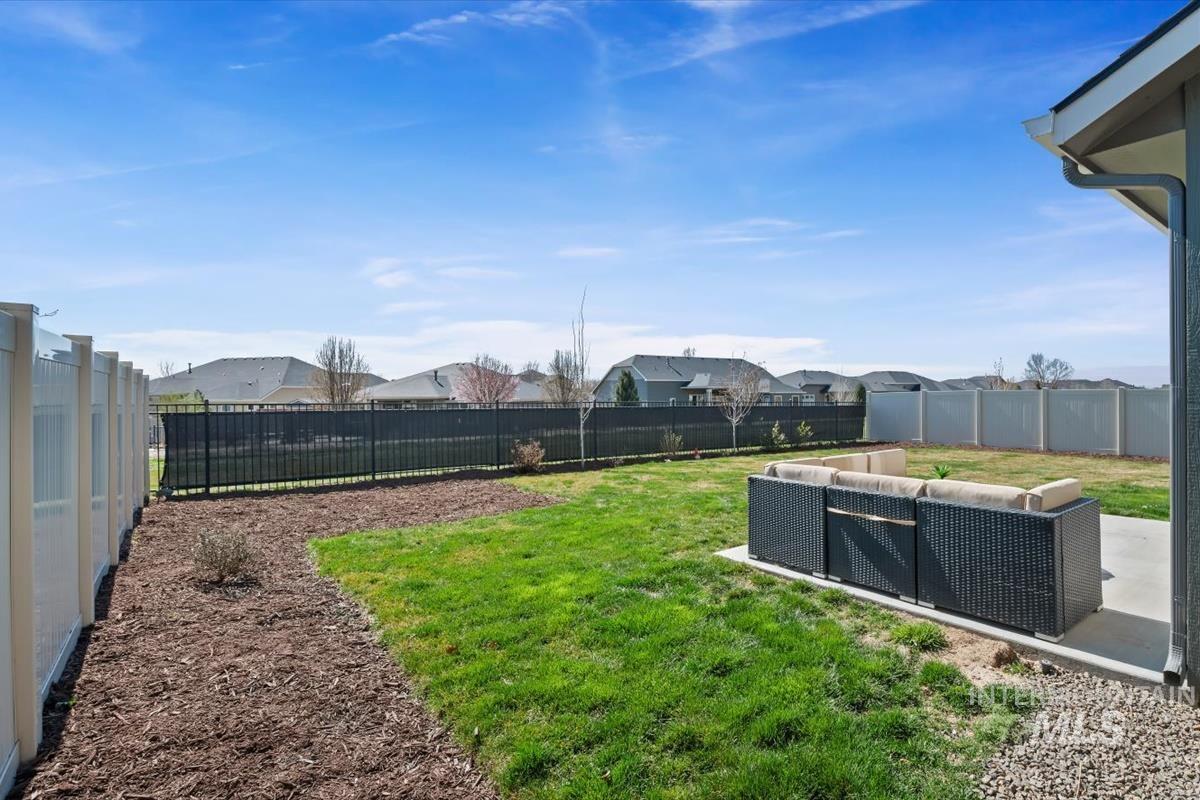11359 West Langit Street Star, ID 83669 - Photo 29 of 39 Fenced backyard with a patio, outdoor lounge area, and a residential view