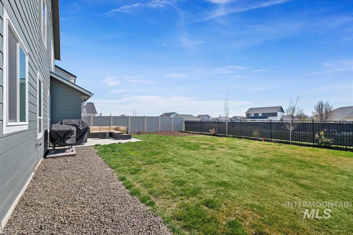 11359 West Langit Street Star, ID 83669 - Photo 30 of 39 Fenced backyard with a patio area and outdoor lounge area