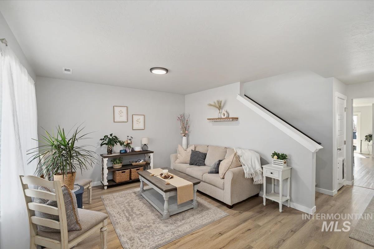 11359 West Langit Street Star, ID 83669 - Photo 4 of 39 Living room with light wood-style flooring and baseboards