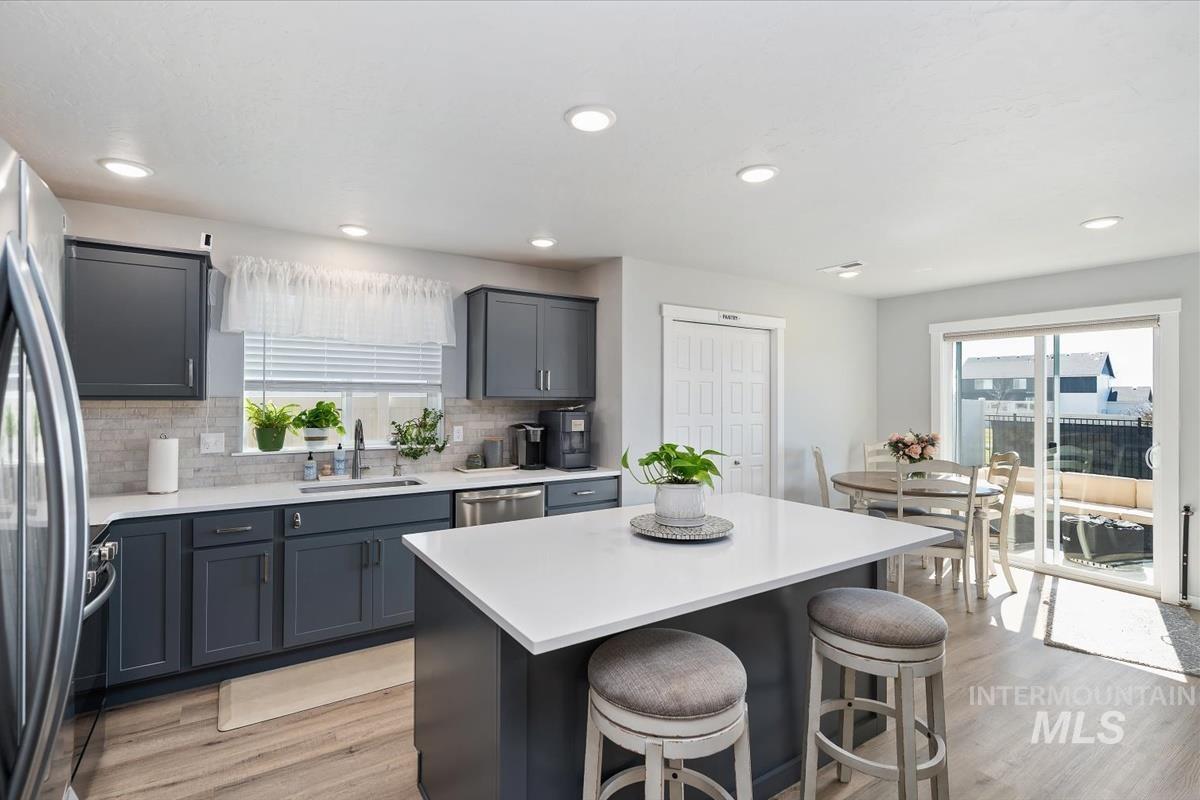 11359 West Langit Street Star, ID 83669 - Photo 5 of 39 Kitchen featuring a kitchen breakfast bar, a center island, stainless steel appliances, plenty of natural light, and recessed lighting