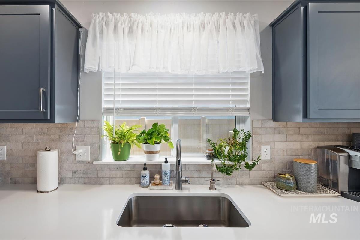 11359 West Langit Street Star, ID 83669 - Photo 8 of 39 Kitchen with light stone counters and decorative backsplash