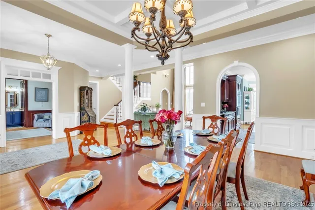 a dining room with furniture and a chandelier